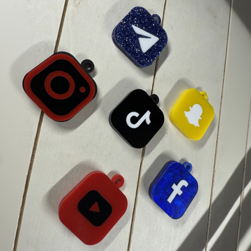 Collection of social media logo cases on a wooden surface